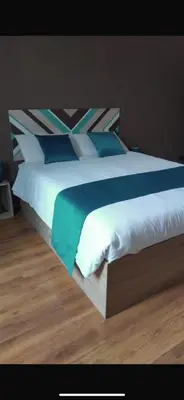 a large bed with blue and white sheets and pillows at Dreamingrome in Rome