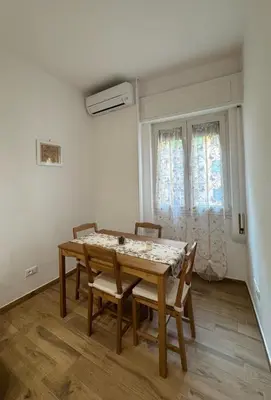 a dining room with a table and chairs and a window at Re di Roma Living in Rome