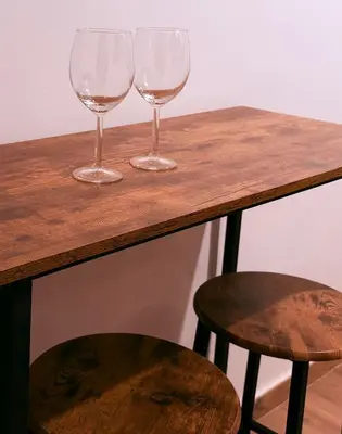 two wine glasses sitting on top of a wooden table at Re di Roma Living in Rome