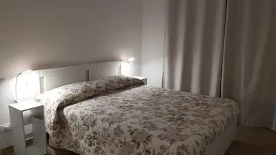 a bedroom with a bed with a white comforter at Re di Roma Living in Rome
