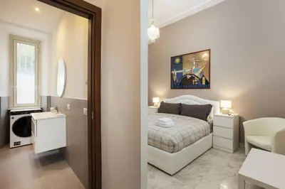 a small bedroom with a bed and a bathroom at Domus Vespignani in Metro Lodi e San Giovanni - The Bright Spot in Rome