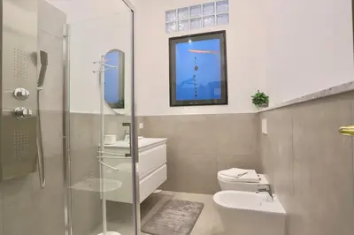 a bathroom with a toilet and a sink and a shower at Domus Vespignani in Metro Lodi e San Giovanni - The Bright Spot in Rome