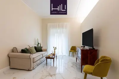 a living room with a couch and a tv at Casa Green by Hili in Rome