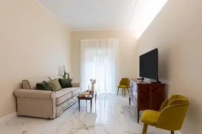 a living room with a couch and a tv at Casa Green by Hili in Rome