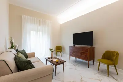 a living room with a couch and a flat screen tv at Casa Green by Hili in Rome