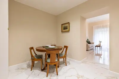 a dining room with a wooden table and chairs at Casa Green by Hili in Rome