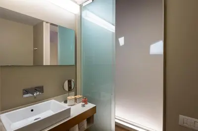 a bathroom with a sink and a glass shower at Coronari Navona luxury 1 bedroom 2 bathrooms in Rome