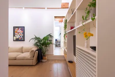a living room with a couch and plants at Coronari Navona luxury 1 bedroom 2 bathrooms in Rome
