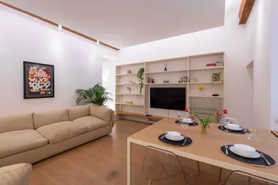 a living room with a couch and a table at Coronari Navona luxury 1 bedroom 2 bathrooms in Rome