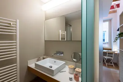 a bathroom with a sink and a mirror at Coronari Navona luxury 1 bedroom 2 bathrooms in Rome
