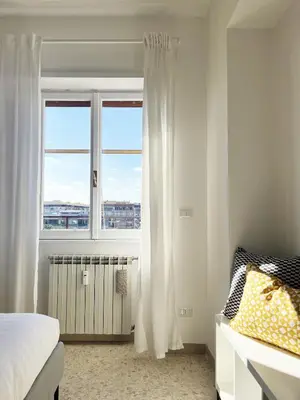 a bedroom with a bed and a window at Yellow Sweet Home in Rome