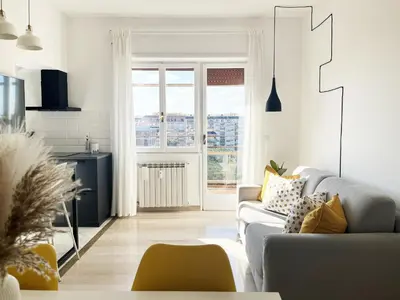 a white living room with a couch and a window at Yellow Sweet Home in Rome