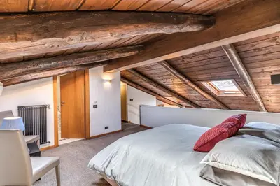 a bedroom with a large bed and wooden ceilings at Massimo 60 apartment by Roman Dreams in Rome