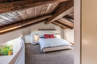 a bedroom with a bed and wooden ceilings at Massimo 60 apartment by Roman Dreams in Rome
