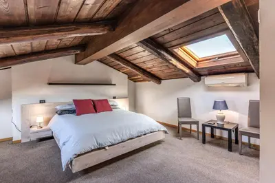 a bedroom with a large bed and a skylight at Massimo 60 apartment by Roman Dreams in Rome