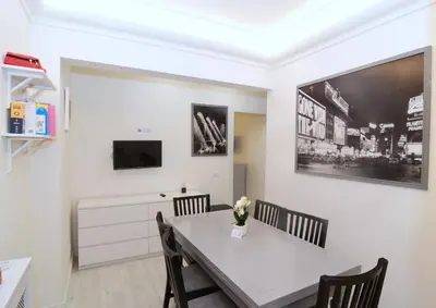 a dining room with a white table and chairs at Roma Metro Apartment in Rome