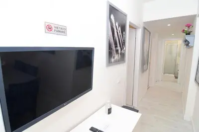 a bedroom with two beds and a picture of a building at Roma Metro Apartment in Rome