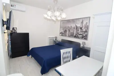 a hallway in a house with white walls and wood floors at Roma Metro Apartment in Rome