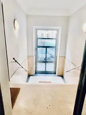 an empty hallway with a door in a building at Palmira house in Rome