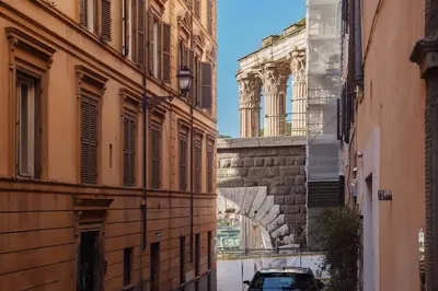 an alley between two buildings with a car on it at Domus Aureliano in Rome