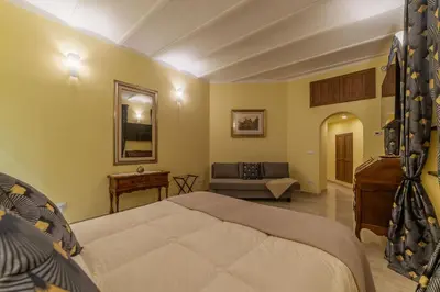 a bedroom with a bed and a couch in it at Domus Aureliano in Rome