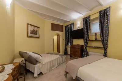 a bedroom with two beds and a dresser in it at Domus Aureliano in Rome