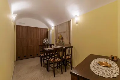 a dining room with a table and chairs at Domus Aureliano in Rome