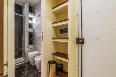 a bathroom with a toilet and a walk in shower at Domus Aureliano in Rome