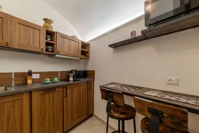 a kitchen with wooden cabinets and a counter top at Domus Aureliano in Rome