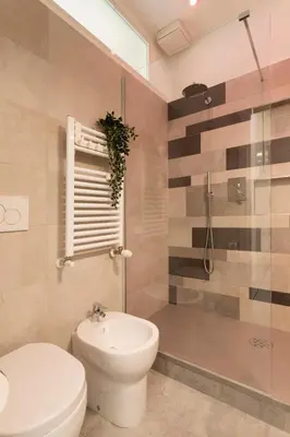 a bathroom with a toilet and a shower and a sink at Grazia Appartamento Moderno & Chic a Tiburtina in Rome