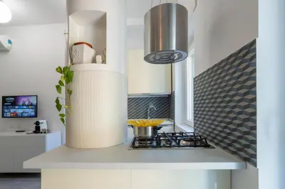 a kitchen with a stove and a sink at Grazia Appartamento Moderno & Chic a Tiburtina in Rome