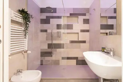 a bathroom with a sink and a toilet and a shower at Grazia Appartamento Moderno & Chic a Tiburtina in Rome