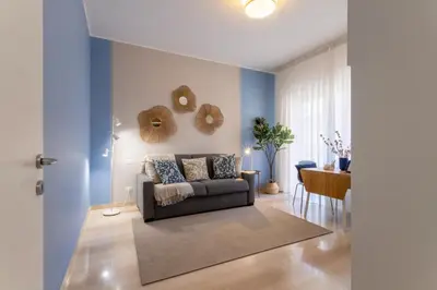 a living room with a couch and a table at Grazia Appartamento Moderno & Chic a Tiburtina in Rome