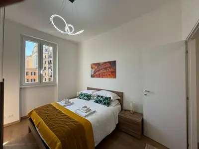 a bedroom with a bed and a window at Urban Retreat Steps from the Metro in Rome