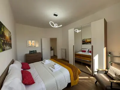 a bedroom with a bed with red pillows at Urban Retreat Steps from the Metro in Rome