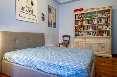 a bedroom with a bed and a book shelf at Camilluccia Home close to St Peter Stadio Olimpico in Rome