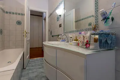 a bathroom with a sink and a mirror and a tub at Camilluccia Home close to St Peter Stadio Olimpico in Rome