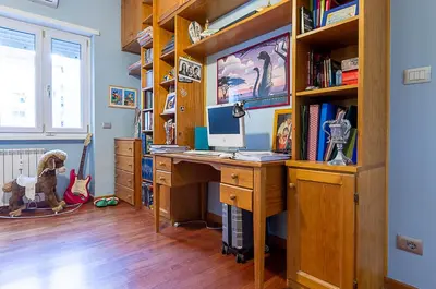 a home office with a computer desk and bookshelves at Camilluccia Home close to St Peter Stadio Olimpico in Rome