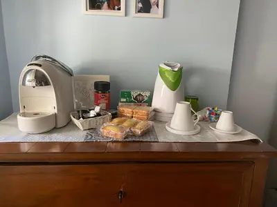 a counter top with a coffee maker and food on it at Camilluccia Home close to St Peter Stadio Olimpico in Rome