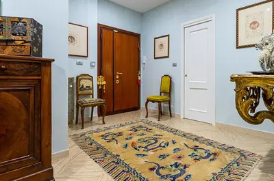 a hallway with a door and some chairs and a rug at Camilluccia Home close to St Peter Stadio Olimpico in Rome