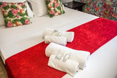 a bed with two towels on a red blanket at Eco Retreat -Sauna & Garden in Rome