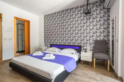 a bedroom with a bed and a chair at Eco Retreat -Sauna & Garden in Rome