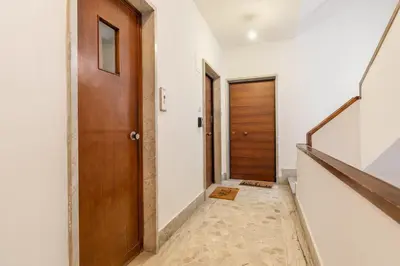 a hallway with a wooden door and stairs at Design Apartment, near Tiburtina Station in Rome