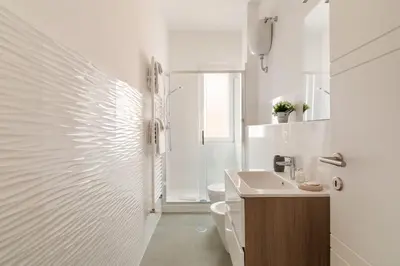 a white bathroom with a toilet and a sink at Design Apartment, near Tiburtina Station in Rome