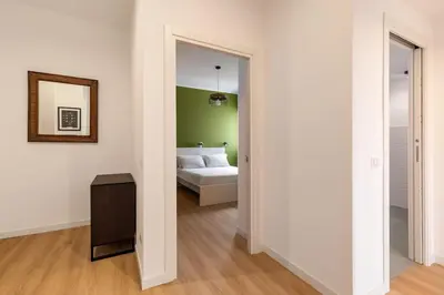 a bedroom with a bed and a mirror at Design Apartment, near Tiburtina Station in Rome