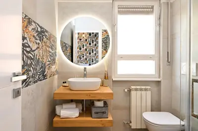 a bathroom with a sink and a mirror at Cozy Studio Steps from Metro station in Rome
