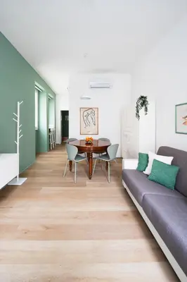 a living room with a couch and a table at New lovely apartment near the metro A in Rome
