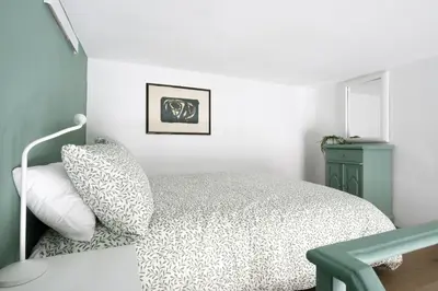 a bedroom with a bed and a blue cabinet at New lovely apartment near the metro A in Rome