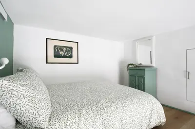 a white bedroom with a bed and a mirror at New lovely apartment near the metro A in Rome