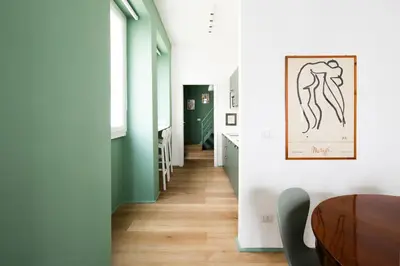 a hallway with green walls and a wooden table at New lovely apartment near the metro A in Rome